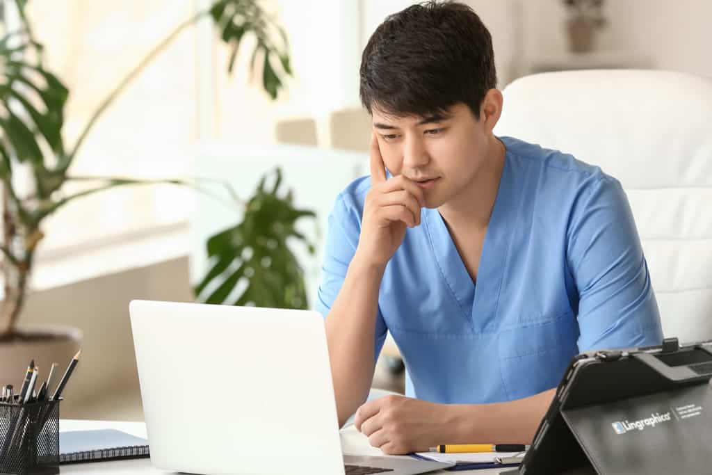 Male speech-language pathologist on a laptop conducting a virtual device trial