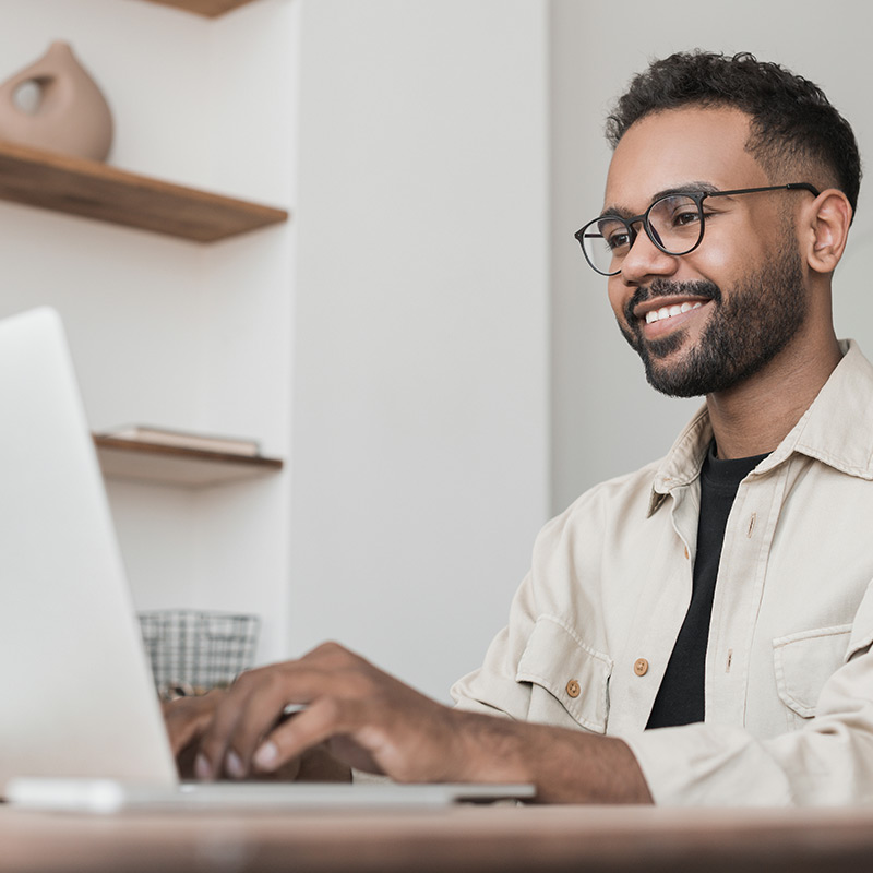 Photo of a young man studying at a laptop