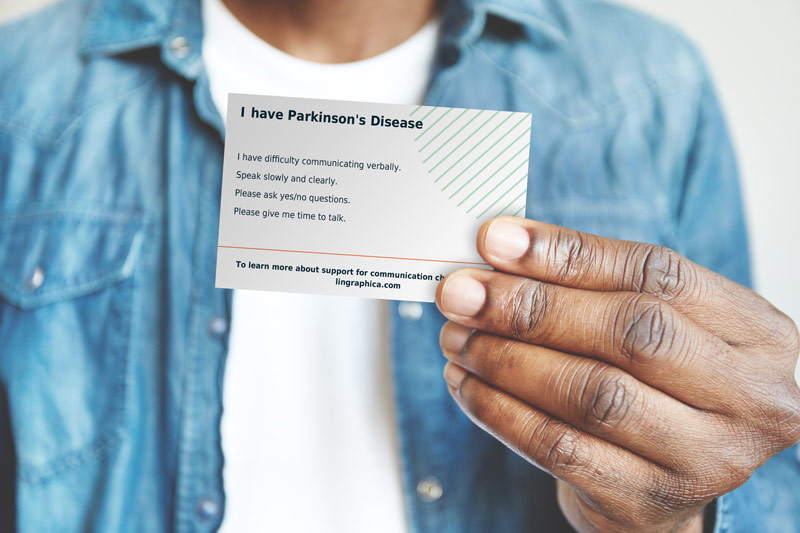 Image of man holding a personalized Parkinson's communication ID card